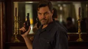Eric brandishes his gun.
