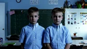 Young twins are in the classroom.