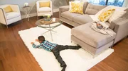 Five year old Julian Silva spreads out on the new rug in his updated living room, as seen on Fixer Upper. (after, action)