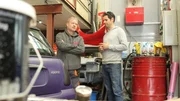 Elvis (r.) and contrib talking with example car.