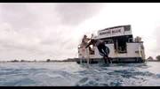 Michael Phelps dives in the water in the Bahamas.