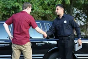 Norman and police officer shaking hands. Norman and police officer shaking hands.