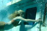 Emma (Claire Holt) versucht den eingeschlossenen Zane (Burgess Abernethy) aus dem untergegangenen Boot von Miss Chatham zu befreien.