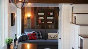 Jennifer Muny's tiny home is gorgeous and rustic with a spacious living area next to large windows that give her an incredible view of the pond she lives next to, as seen on Tiny House, Big Living. Jennifer Muny's tiny home is gorgeous and rustic with a spacious living area next to large windows that give her an incredible view of the pond she lives next to, as seen on Tiny House, Big Living.