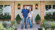 As seen on Fixer Upper, Chip and Joanna Gaines in front of the Barker's newly remodeled home. (Portrait)