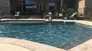 A wide shot of the Keck yard shows how perfectly the deep teal pool adds the perfect pop of color to the Keck home. A wide shot of the Keck yard shows how perfectly the deep teal pool adds the perfect pop of color to the Keck home.