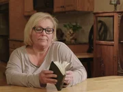 Cindy Moore looking through mom?s devotional book during interview. Cindy Moore looking through mom?s devotional book during interview.