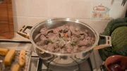 Ein Topf, in dem ein Pferdefleischeintopf k&ouml;chelt &ndash; zarte Fleischst&uuml;cke, Wein und duftende Kr&auml;uter.