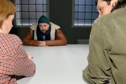 John (Felix von Jascheroff, M.) l&auml;sst sich beim Verh&ouml;r durch Toni (Olivia Marei, l.) und ihren Kollegen Holger Schmitt (Timo Hastenpflug) nicht aus der Reserve locken.