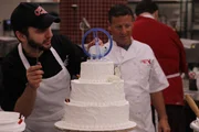 Ralph and Joe adding sculpted animals to cake. Ralph and Joe adding sculpted animals to cake.