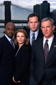 L-R: Ron Carver (Courtney B. Vance), Detective Alexandra Eames (Kathryn Erbe), Detective Robert Goren (Vincent D'Onofrio), Captain James Deakins (Jamey Sheridan)