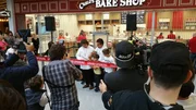 Ribbon cutting ceremony at bakery opening. Ribbon cutting ceremony at bakery opening.