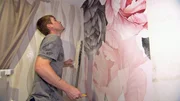 Peter tapeziert die Wand des zuk&uuml;nftigen Kinderzimmers