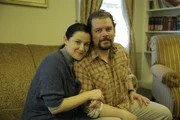 Kimberly and Brian are on a couch. Kimberly and Brian are on a couch.