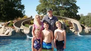 The fleming family standing pool side smiling, as seen on Pool Kings.