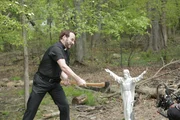 Eddie Sexton uses an ax to cut a Jesus statue.