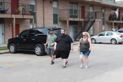 Chris (m.) walking with family outside apartment Chris (m.) walking with family outside apartment