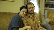 Kimberly and Brian are on a couch. Kimberly and Brian are on a couch.