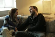 Randall and Linda talk on the couch.