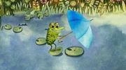 Der Frosch freut sich. Der Wind hat ihm einen kleinen blauen Schirm zugeweht. Er hält ihn für einen Windfänger zum Surfen. Der Frosch freut sich. Der Wind hat ihm einen kleinen blauen Schirm zugeweht. Er hält ihn für einen Windfänger zum Surfen.
