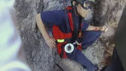 A Rescue team member watches Hongbo Zhao taken to safety.