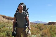 Ed is in a scrubby desert with a pack.