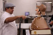 Buddy steams the finished Sherlock Holmes cake to give it a shiny look.