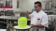 Buddy sprays the pineapple cake to give it texture and the right color.