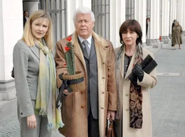 Friedrich (Peter Weck) kommt gerade mit seiner Gattin Anna (Heidelinde Weis, re.) und Tochter Carolin (Katharina Schubert) von seiner Abschiedsvorlesung.