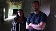 Hosts Nick Groff and Katrina Weidman stand in a hallway.