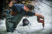 Ryan Cardoza uses the ten-foot drill bit extension to help Fred Hurt remove large boulders from the creek Ryan Cardoza uses the ten-foot drill bit extension to help Fred Hurt remove large boulders from the creek
