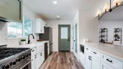 Interior shot of the kitchen after renovation, as seen on Fix My Flip, Season Two.