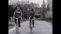 Premierminister Wilfried Martens radelt mit einem Nachwuchsfahrer.