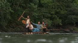 Die Backpacker Yossi (Daniel Radcliffe, l.), Marcus (Joel Jackson, 2.v.l.) und Kevin (Alex Russell, 2.v.r.) setzen euphorisch ihre Dschungelexpedition auf einem selbstgebauten Flo&szlig; fort, nachdem sie ihren Expeditionsf&uuml;hrer Karl (Thomas Kretschmann, r.) zur Weiterreise &uuml;berzeugt haben.