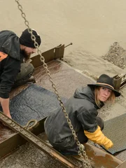 Karla Ann Charlton and Mark Doverspike cleaning mats, top shot