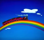 Der Wunderlandzug hat vom Erdboden abgehoben und f&auml;hrt &uuml;ber den Regenbogen.