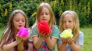 Im Garten bringen Kinder Blumen zum Bl&uuml;hen, die nicht in der Erde wachsen.
