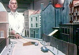 Ed (John Karlsen), der Chef, erkl&auml;rt seinen Komplizen die Strategie des &Uuml;berfalls auf eine Londoner Bank.