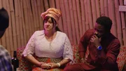 Lisa Rosenberger and Daniel Ugwu listen to Daniel's Uncle speak.