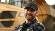 Ben Bellai smiling by rock truck Ben Bellai smiling by rock truck
