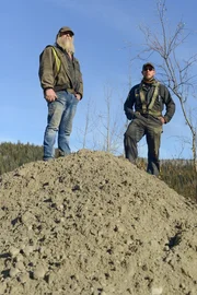 Tony Beets and Kevin Beets stood on mound of dirt, chatting Tony Beets and Kevin Beets stood on mound of dirt, chatting