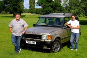 Field location with Mike standing in front Land Rover and Elvis standing beside Land Rover. Field location with Mike standing in front Land Rover and Elvis standing beside Land Rover.