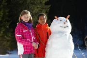 Nahas und Paula lassen sich mit ihrem gerade gebauten Schneemann fotografieren. Nahas und Paula lassen sich mit ihrem gerade gebauten Schneemann fotografieren.