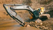 Rick Ness sinking a Volvo excavator in deep mud while attempting to mine for gold. Rick Ness sinking a Volvo excavator in deep mud while attempting to mine for gold.