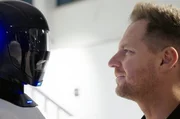 Auge in Auge mit dem Beitragszahler von morgen: Der Robotik-Unternehmer David Reger (re.) w&uuml;nscht sich, dass humanoide Roboter wie der "4NE1" k&uuml;nftig in die Sozialkassen einzahlen.