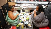 Nesha Harris & Jasmine Wallace eating sushi.