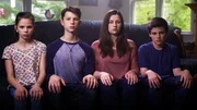 The Fuss children sitting on the couch.