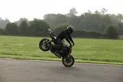 London, UK: A motorbiker performing a stoppie. London, UK: A motorbiker performing a stoppie.