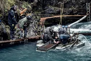 Dustin Hurt and Carlos Minor standing by the edge of the dive site looking at James Hamm and Wesley Richardson searching the sluice box. Dustin Hurt and Carlos Minor standing by the edge of the dive site looking at James Hamm and Wesley Richardson searching the sluice box.