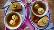 Beauty shot of Molly Yeh's Pastrami Sandwiches with Onion Rings, Chicken Kreplach Soup, and Black & Pink Cookies, as seen on Girl Meets Farm, Season 7. Beauty shot of Molly Yeh's Pastrami Sandwiches with Onion Rings, Chicken Kreplach Soup, and Black & Pink Cookies, as seen on Girl Meets Farm, Season 7.